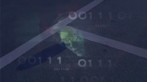 Translucent green skull floating above asphalt road streaming binary code over Stock Footage 307458447