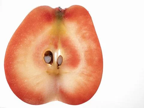 Translucent half slice of red-fleshed apple isolated on white background Foto stock