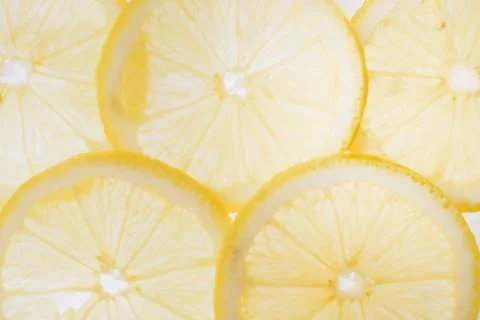 Translucent lemon slices on a white background, citrus fruit slices Stock Photos