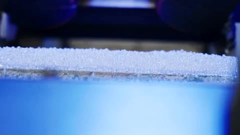 Translucent Plastic Pellets on Conveyor Edge, Blue Macro Backlight, Side View Stock Footage 341301341