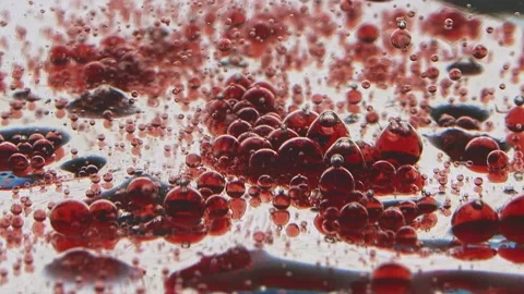 Translucent red drops slowly fall on the jelly-like surface Stock Footage 132188572