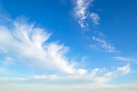Translucent scenic cirrus clouds high in a blue sky. Cloud species. Stock Photos