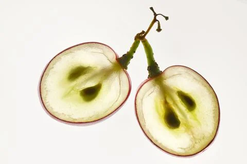 Translucent Slice Of Red Grape With Seeds In A Cut Stock Photos