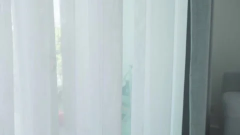 The translucent white curtains at the front door fluttered in the wind. Stock Footage 234795289