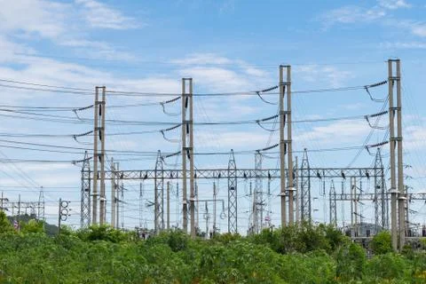 Transmission High voltage electricity pylon with blue sky background Stock Photos