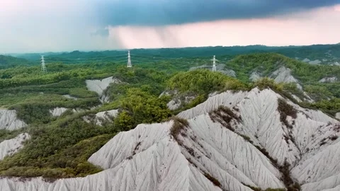 Transmission tower in the old mud volcano area of Tianliao during misty Stock Footage 257394362