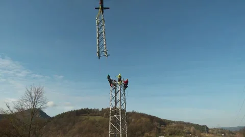 Transmission Tower Section Lowered onto Utility Workers Stock Footage 346303441