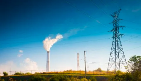 Transmission Tower with Smoke-Stack of Electrical Power Plant Stock Photos