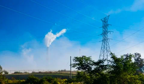 Transmission Tower with Smoke-Stack of Electrical Power Plant Stock Photos