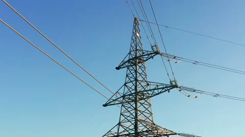 Transmission tower supporting an overhead high voltage power line Stock Footage 138718962