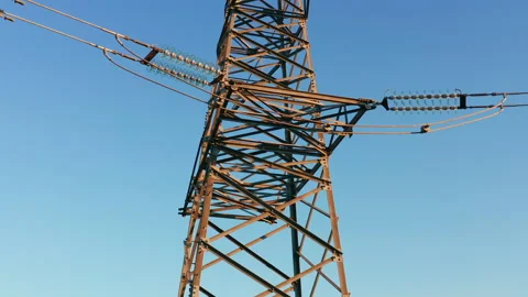 Transmission tower supporting an overhead high voltage power line Stock Footage 138723857
