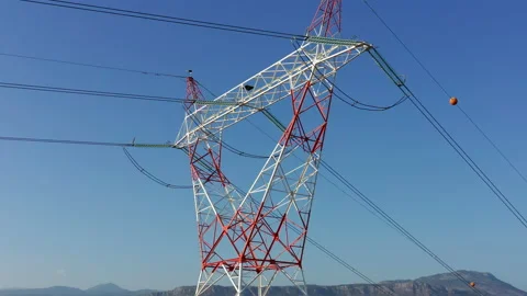 Transmission tower supporting an overhead high voltage power line Stock Footage 139019780