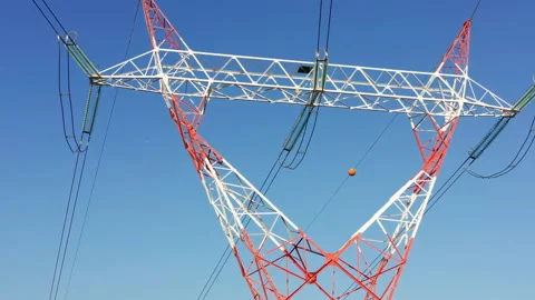 Transmission tower supporting an overhead high voltage power line Stock Footage 139020844