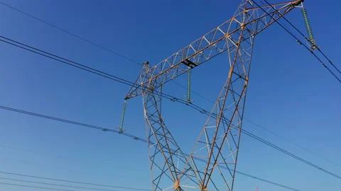 Transmission tower supporting an overhead high voltage power line Stock Footage 139021889