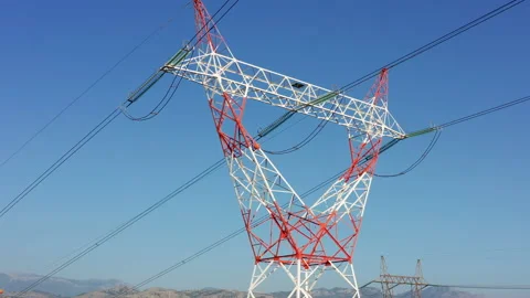 Transmission tower supporting an overhead high voltage power line Stock Footage 139025829