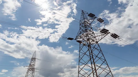 Transmission tower supporting an overhead high voltage power line - time lapse Stock Footage 309417120