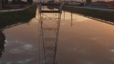Transmission tower water reflection at Sunrise, Countryside of Japan, TIlt Up Stock Footage 344853950