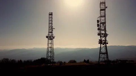 Transmission towers on a mountain in the backlight Stock Footage 142901488
