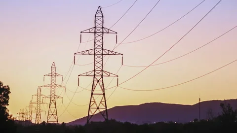 Transmission Towers Of Power Grid At Dusk - Time Lapse Stock Footage