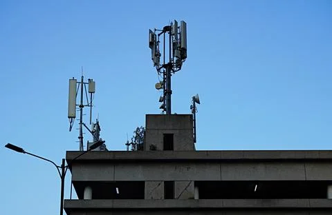 Transmitter on a medium-high building for mobile phone lines Stock Photos