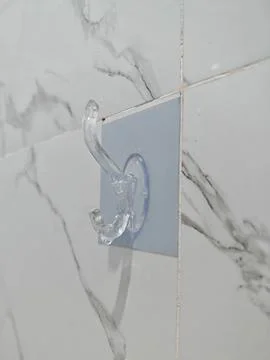 Transparent Adhesive Double Wall Hook on Marble Tile Stock Photos