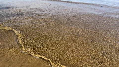 Transparent and smooth as a roll of silk, the waves roll easily and calmly onto Stock Footage 286846009