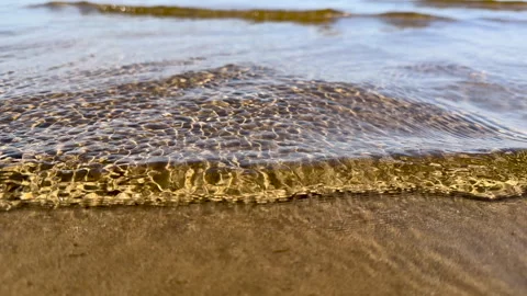 Transparent and smooth as a roll of silk, the waves roll easily and calmly onto Stock Footage 289230219