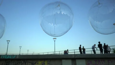 Transparent balloon and the blue sky. Girl walking through Stock Footage 157967940