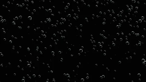 Transparent balls filled with air. Bubbles rise up on a black background. Stock Footage 117354544