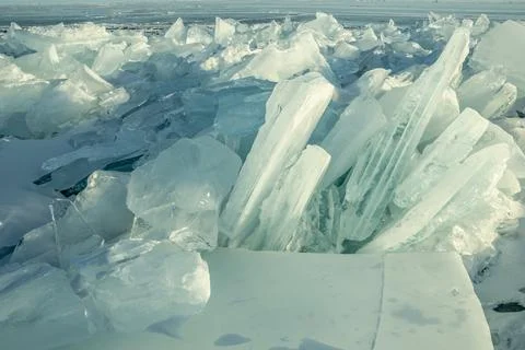 Transparent block of ice in the rays of the sun at sunset. Winter natural a.. Stock Photos