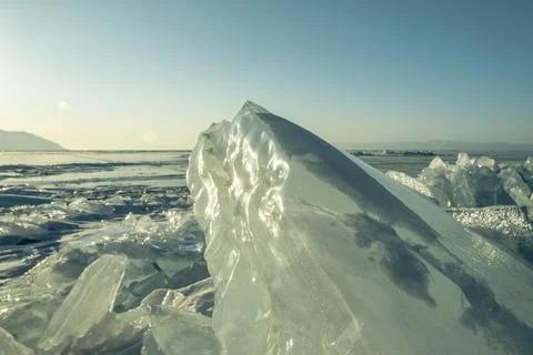 Transparent block of ice in the rays of the sun at sunset. Winter natural a.. Stock Photos
