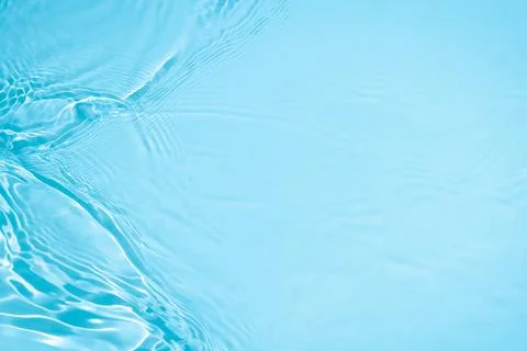 Transparent blue colored clear calm water surface texture Illustrazione stock