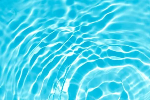 Transparent blue colored clear calm water surface texture Stock Photos
