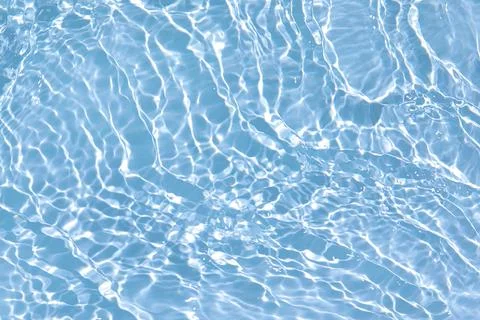 Transparent blue colored clear calm water surface texture Stock Photos