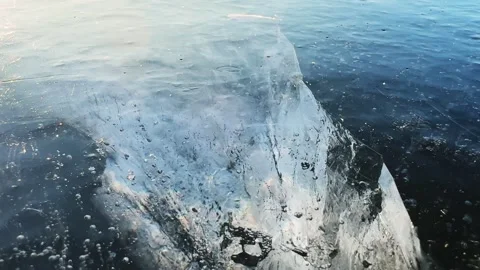 Transparent blue ice with cracks and bubbles on the frozen lake. Stock Footage 298178309