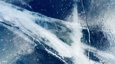 Transparent blue ice with cracks and bubbles on the frozen lake. Stock Footage 298179866