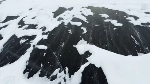 Transparent blue ice with cracks and bubbles on the frozen lake. Stock Footage 298183174