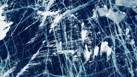 Transparent blue ice with cracks on Baikal lake in winter. Video stock 219956178