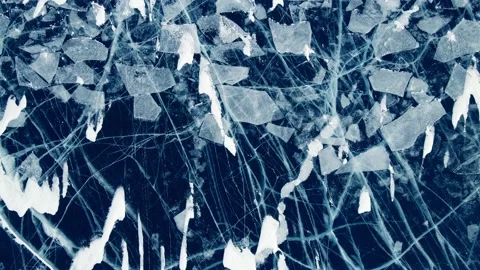 Transparent blue ice with cracks on Baikal lake in winter. Video stock 219964533