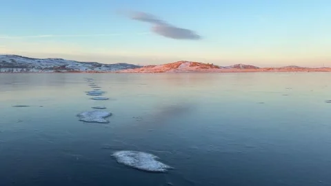 Transparent blue ice on the lake at sunset. Stock Footage 298178631