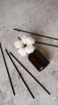 Transparent bottle of aroma diffuser. Parfum for home with cotton flowers Stock Photos
