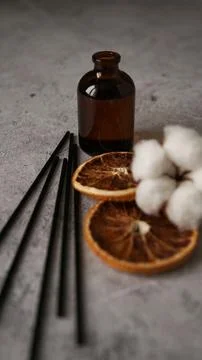 Transparent bottle of aroma diffuser. Parfum for home with cotton and orange Stock Photos