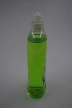 A transparent bottle with a plastic cap, toxic green liquid gel. Stock Photos