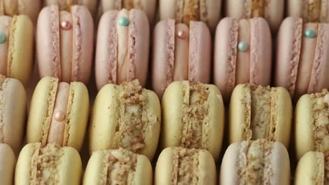 Transparent box full of fresh yellow and pink macaroons cookies Stock Footage 218119236