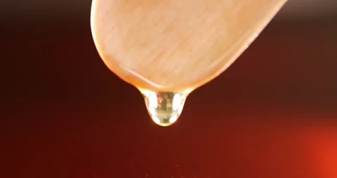 Transparent brown red liquid drips from wooden stick slow motion 4k movie Stock-Footage 257293478