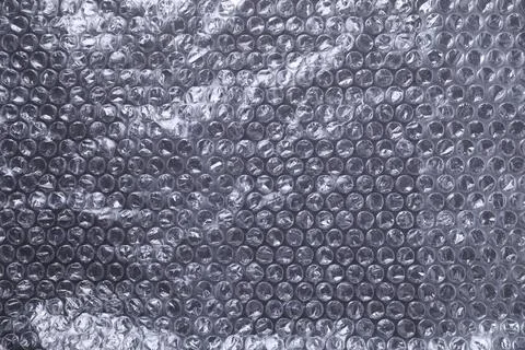 Transparent bubble wrap on black background, top view Stock Photos