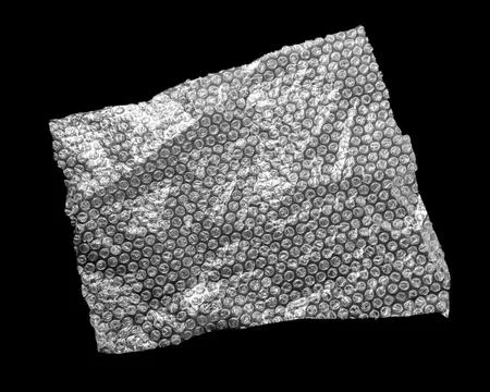 Transparent bubble wrap on black background, top view Stock Photos