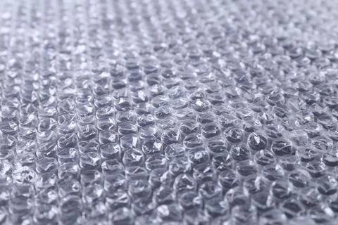 Transparent bubble wrap on black background, closeup Stock Photos