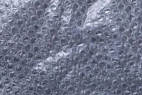 Transparent bubble wrap on black background, top view Stock Photos