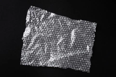 Transparent bubble wrap on black background, top view Stock Photos